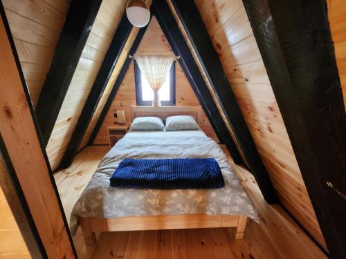 a bed in a small room with a window at Villas Sunny Hill in Žabljak