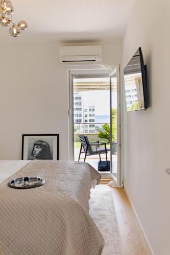 a bedroom with a bed and a view of a patio at A Riduli in Split