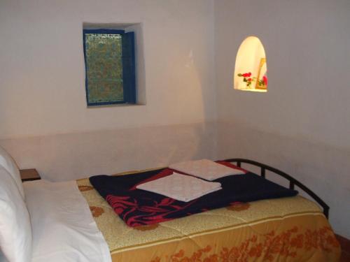 Una cama o camas en una habitación de Palmeraie Guest House