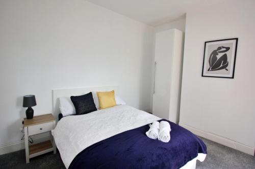 Un dormitorio con una cama con zapatos. en Exceptionally Stunning Four Bed Terraced House With Two Bathrooms- Recently Renovated en Spon End