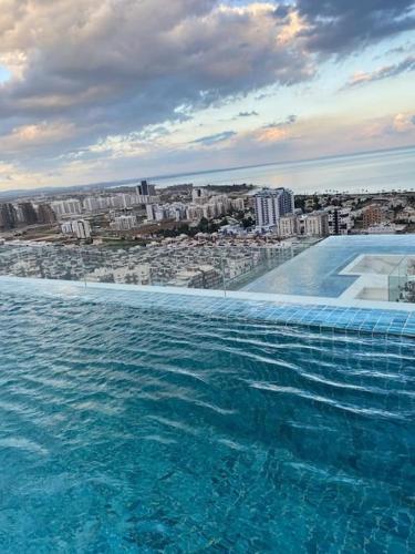a swimming pool with a view of a city at Grand Sapphire 107 Amazing 1 Bedroom Apartment By MyGuest Cyprus in Iskele