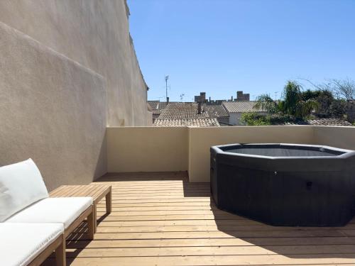 a bath tub sitting on top of a balcony at Les suites du 13 in Aigues-Mortes