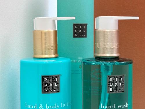 two bottles of hand and body lotion sitting next to each other at Les suites du 13 in Aigues-Mortes