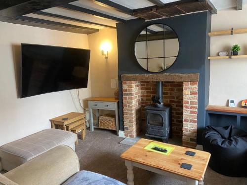 a living room with a couch and a fireplace at Rustic Retreat cottage in Thirsk