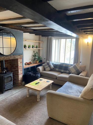 a living room with a couch and a table at Rustic Retreat cottage in Thirsk