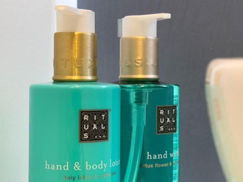two bottles of hand and body lotion next to each other at Les suites du 13 in Aigues-Mortes