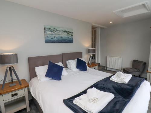 a bedroom with a bed with blue and white pillows at Castle View in Scarborough