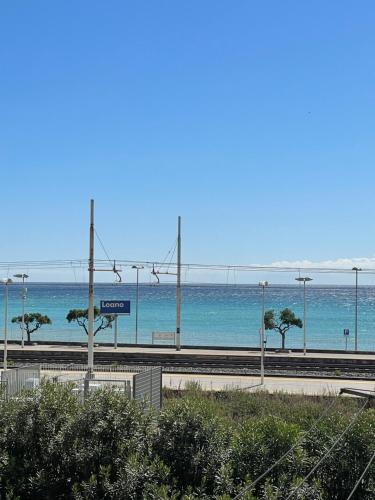 a train station with the ocean in the background at Bellavista-Bilocale-Loano in Loano
