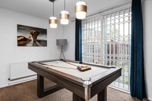 a billiard table in a room with a window at Majestic Gem - Pool Table - Coop - Etihad - Parking in Manchester
