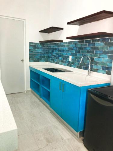 a blue kitchen with a sink and blue tiles at 2-Bedroom Condo by the Jungle w/ Swimming pool in Puerto Morelos