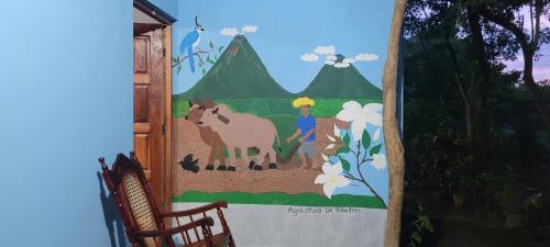 a mural of a girl and a horse on a wall at Hostal Xilotl in San José del Sur