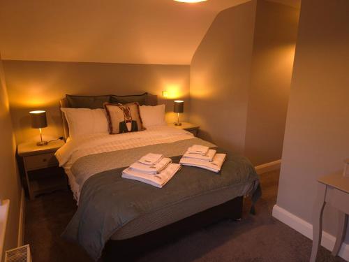 a bedroom with a bed with two towels on it at River View Apart Doolin in Doolin