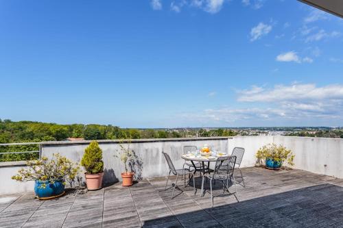 a patio with a table and chairs on a balcony at Beautiful T3 with large terrace - Anglet - Welkeys in Anglet