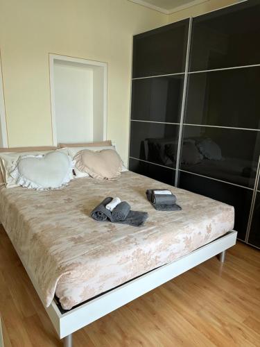 a bed with two pairs of shoes on it at Feriolo Nautique Apartments in Baveno