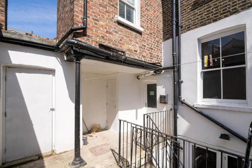 a garage with a door and a brick building at SIDNEY in London