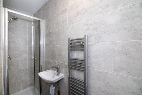 a bathroom with a sink and a shower at SIDNEY in London