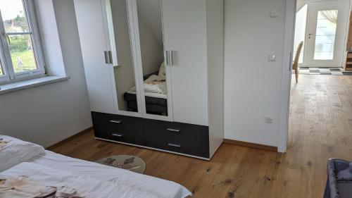 a bedroom with a dresser with a mirror at Ferienwohnung im Thermenland in Fürstenfeld