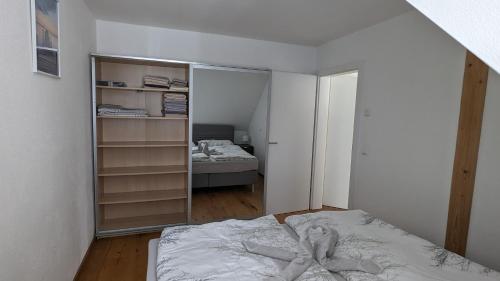 a bedroom with a bed and a mirror at Ferienwohnung im Thermenland in Fürstenfeld