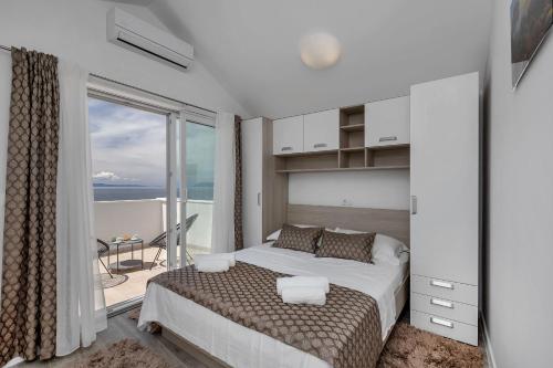 a bedroom with a bed with a view of the ocean at Villa No stress in Drasnice