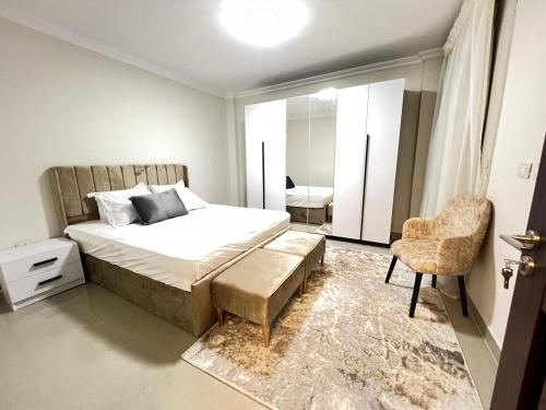 a bedroom with a bed and a chair at Property Sisters, Elite apartment, B11 in Madinaty