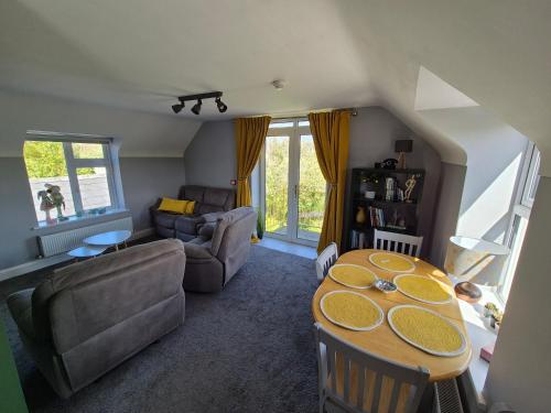 a living room with a table and a couch at River View Apart Doolin in Doolin