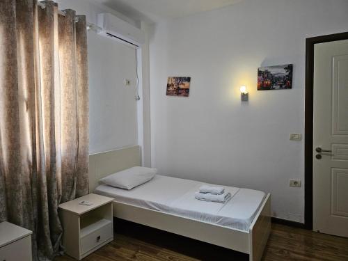 a small room with a small bed and a window at Sea's Villa in Ksamil