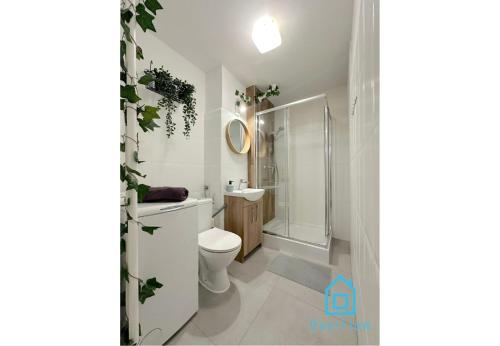 a bathroom with a toilet and a shower at Jager Room 10 Min to Old Town Gdańsk,PKP & Shopping Mall in Gdańsk