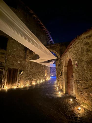 an alley way at night with lights on it at Via Castello 17 in Bienno
