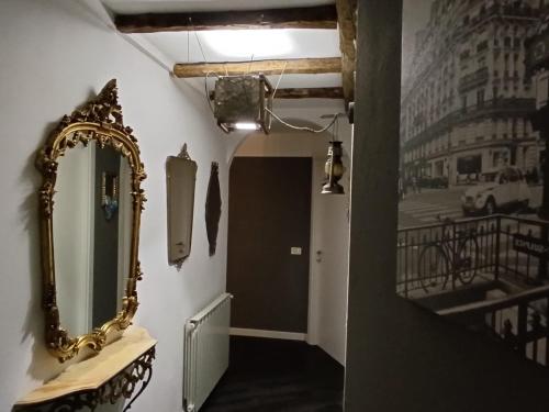 a mirror on a wall next to a hallway at Via Castello 17 in Bienno