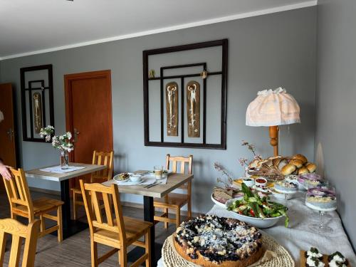 a dining room with a table with food on it at Gawra in Wetlina