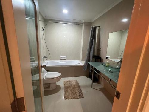 a bathroom with a toilet and a tub and a sink at Parkview KLCC ITSKAYA 11 in Kuala Lumpur