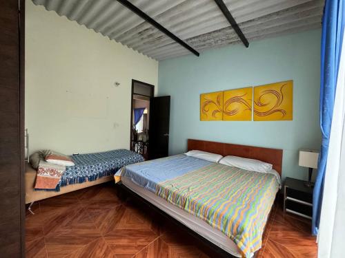 a bedroom with two beds and a mirror at Hospedaje RM in Villeta