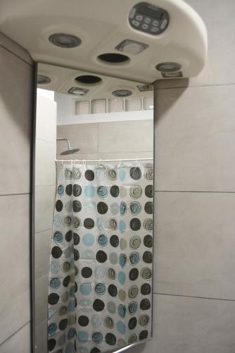 a bathroom with a shower with a shower curtain at Sea Apartment Golem in Golem