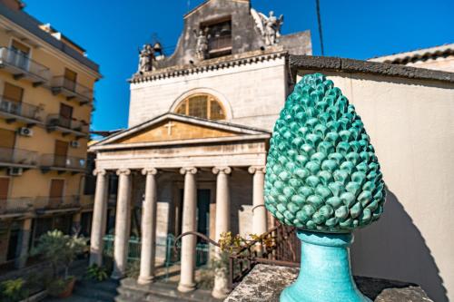 a green pineapple statue in front of a building at Grace's House in Acireale