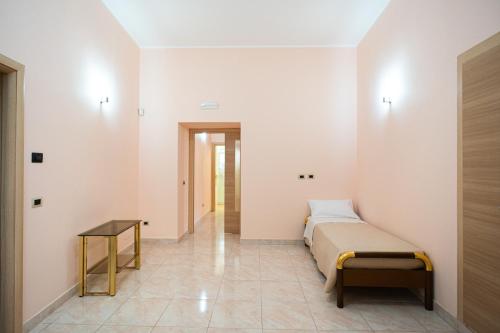 a bedroom with a bed and a table at Grace's House in Acireale