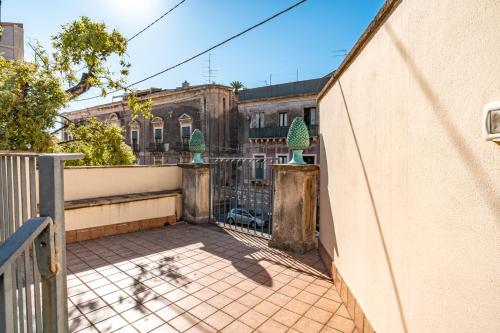 an empty balcony of a building with a fence at Grace's House in Acireale