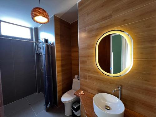 a bathroom with a toilet and a sink and a mirror at Gamora Hotel Playa in Los Órganos