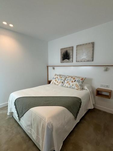 a bedroom with a bed with two pictures on the wall at Ventana del Nublo 1-I in Tejeda