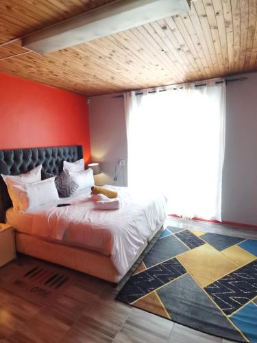 1 dormitorio con cama y ventana grande en Neo & Ruks Guest house Parow, en Ciudad del Cabo