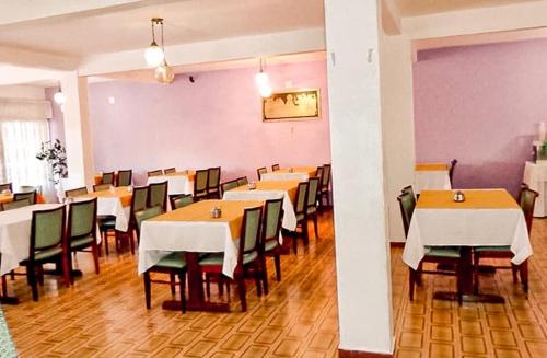 a dining room with tables and chairs in it at Hotel 15 de Julho in Foz do Iguaçu
