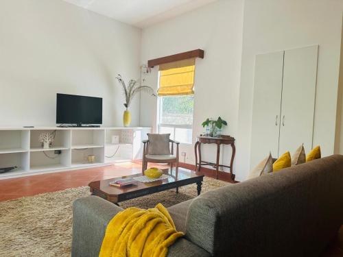 a living room with a couch and a coffee table at Hotel Los Palomos in Lunahuaná