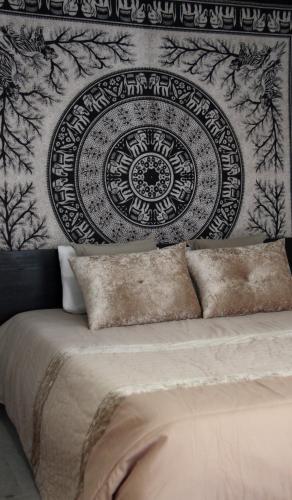 a bed in a room with a wall with a clock at Casa Bella Vista in Fafe