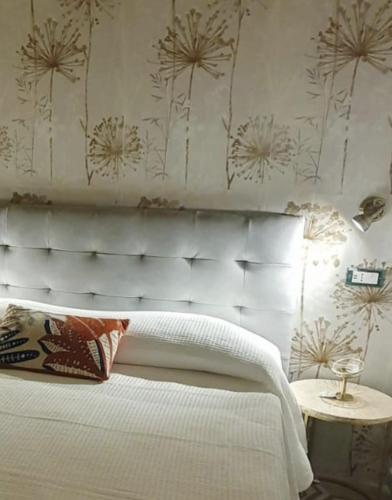a bedroom with a white bed and a table at Azzurra Home in Terrasini