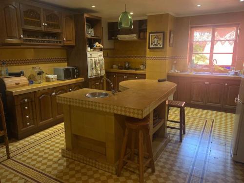 a kitchen with a large island in the middle of it at EL REFUGIO DE NAELA in Coltauco