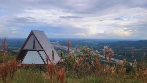 a small house sitting on top of a hill at Guayupes Hotel de Aventura in Guamal
