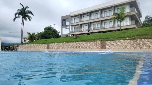 a large swimming pool in front of a building at Guayupes Hotel de Aventura in Guamal