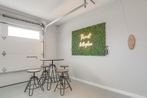 a room with stools and a painting on the wall at Benton Harbor Home with Fire Pit - 2 Mi to Beach! in Benton Harbor