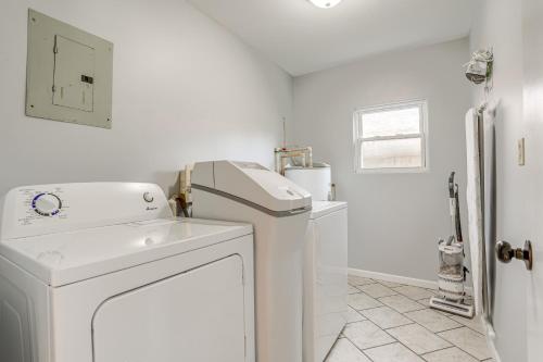 a white laundry room with a washer and dryer at Benton Harbor Home with Fire Pit - 2 Mi to Beach! in Benton Harbor