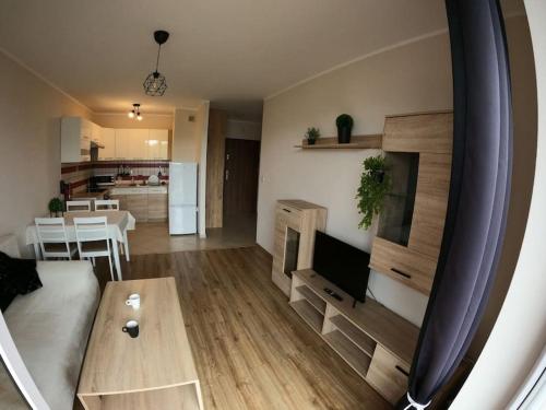 a living room with a couch and a table at Apartament Bażantów in Katowice