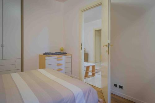 a bedroom with a bed and a dresser and a mirror at Casa Daniel in Seriate
